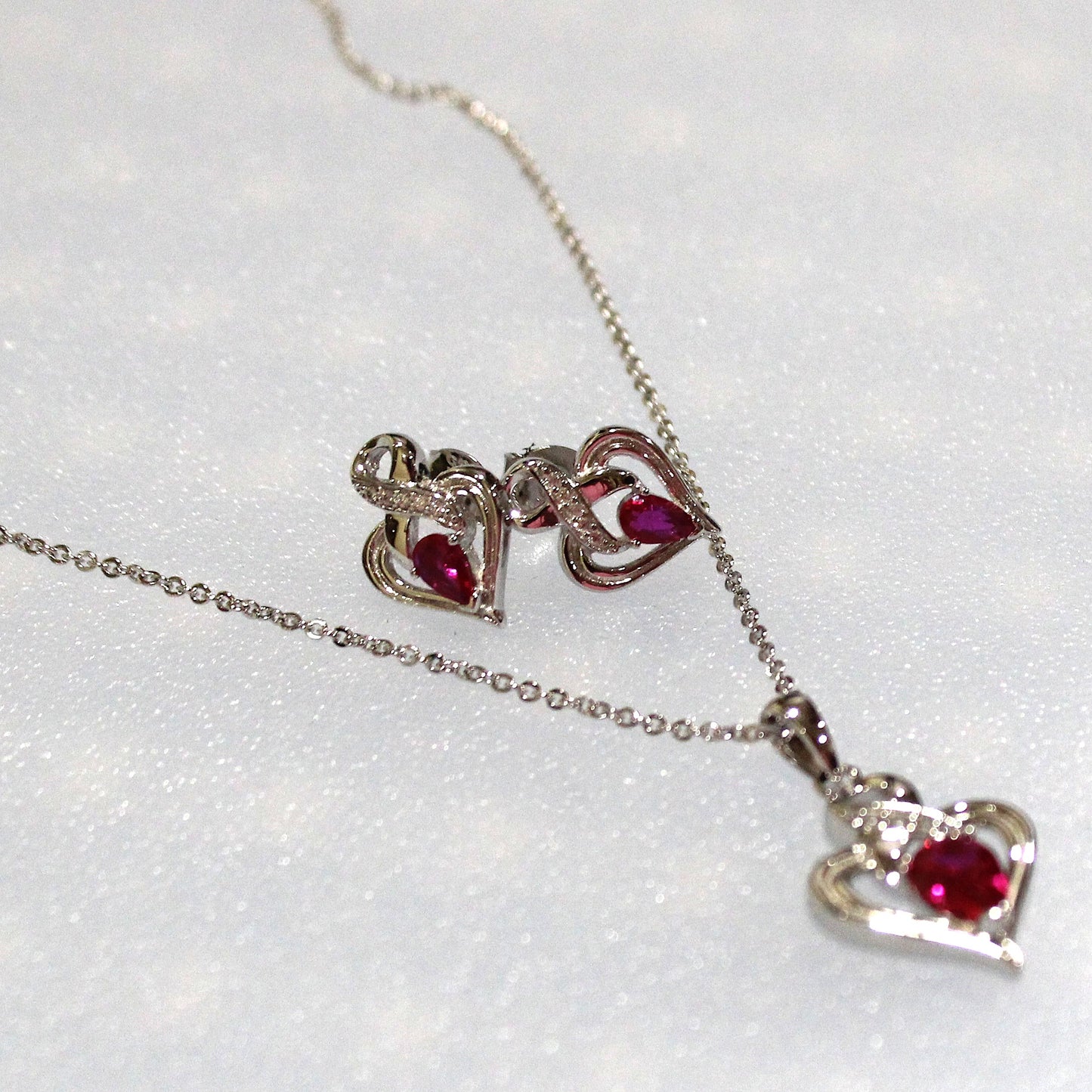 Melanie: Rhodium-plated .925 Sterling lab-created Ruby Ribbon Heart Necklace