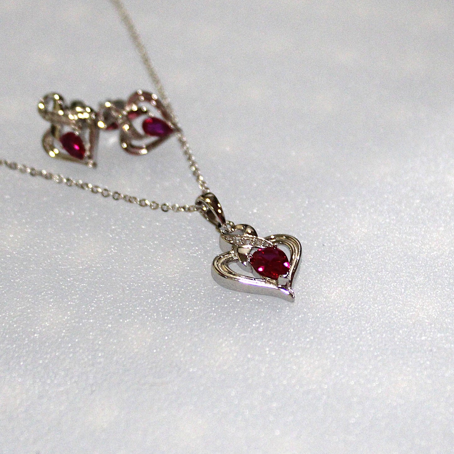 Melanie: Rhodium-plated .925 Sterling lab-created Ruby Ribbon Heart Necklace