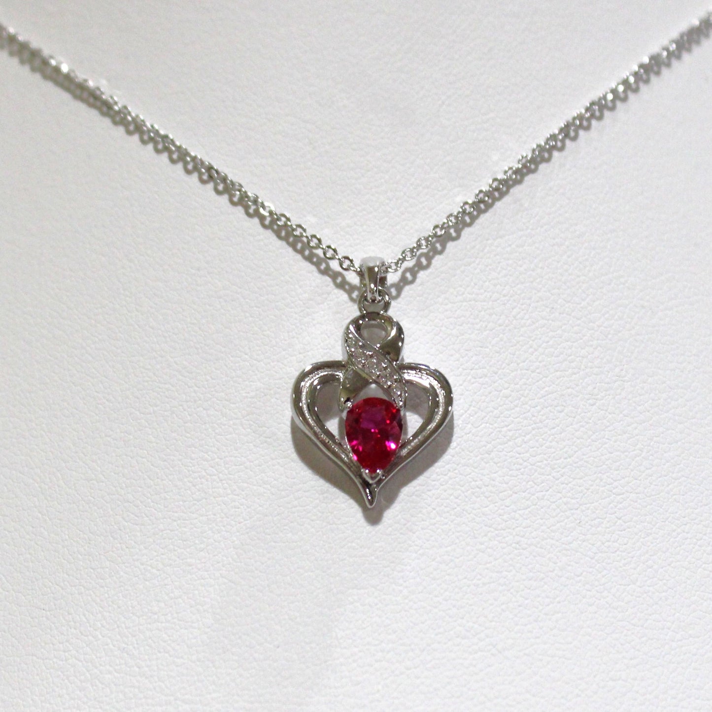 Melanie: Rhodium-plated .925 Sterling lab-created Ruby Ribbon Heart Necklace