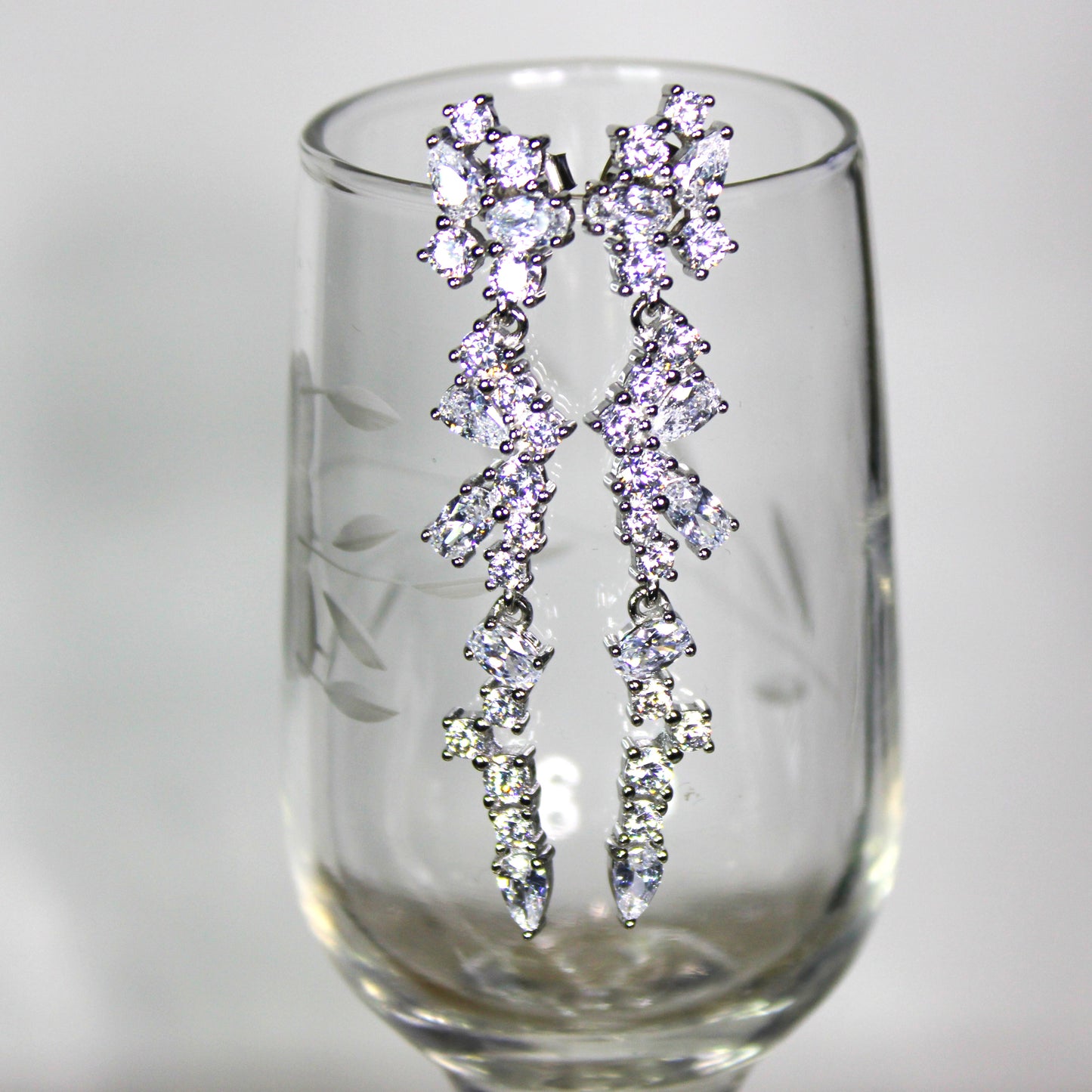 Angela: Rhodium-plated .925 Sterling lab-created Round and Pear Diamond Cluster Drop Set