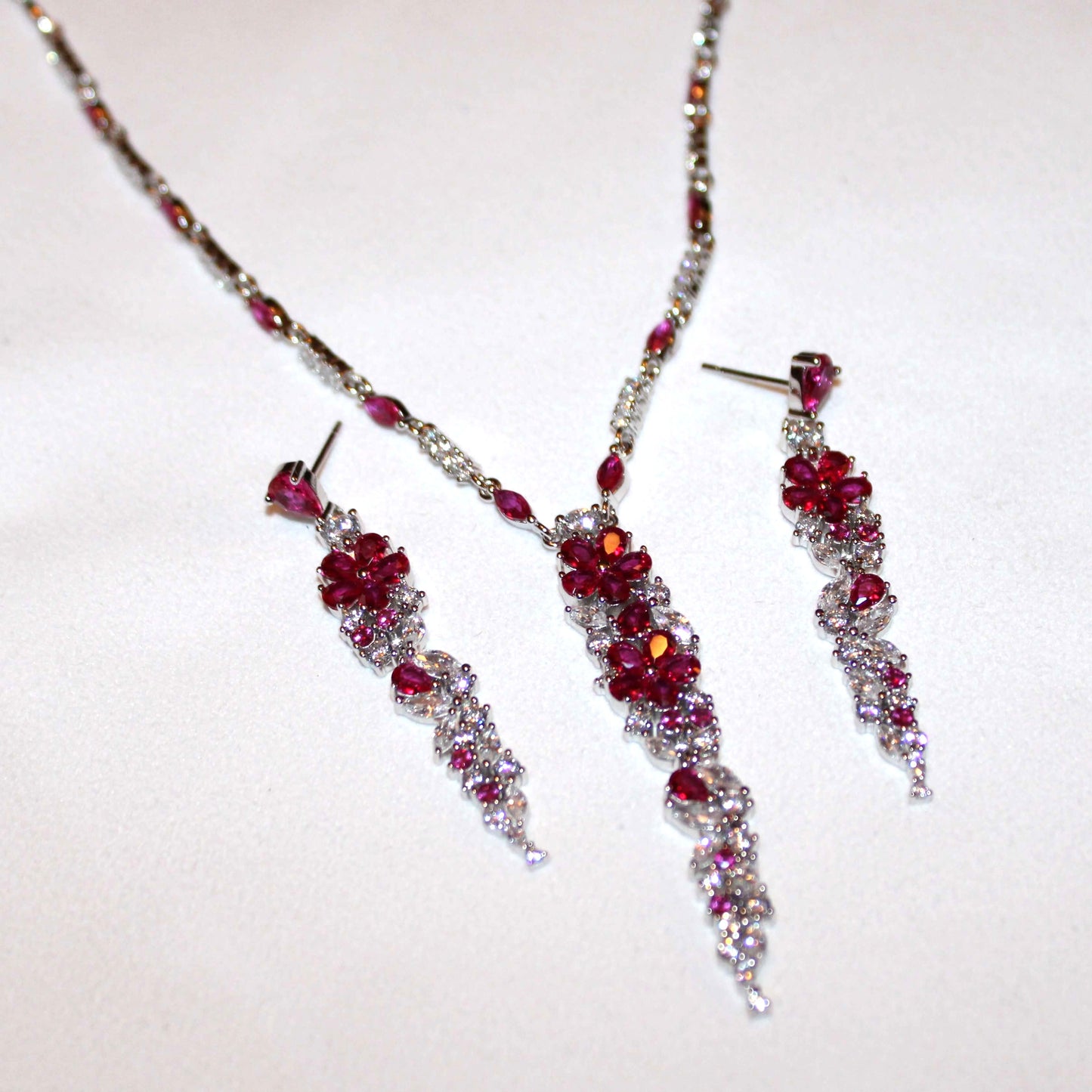 Cassandra: Rhodium-plated .925 Sterling Round Diamond and Teardrop Ruby Necklace and Earrings (Set)