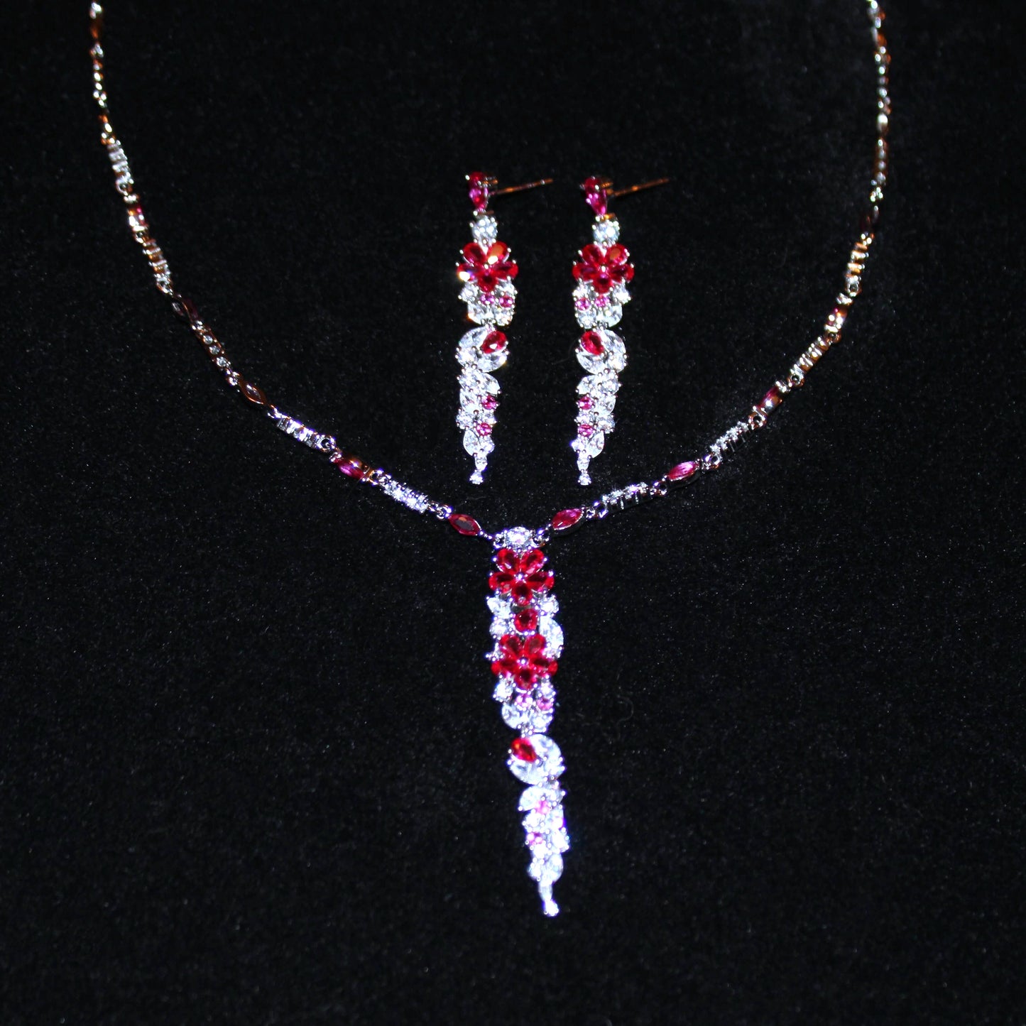 Cassandra: Rhodium-plated .925 Sterling Round Diamond and Teardrop Ruby Necklace and Earrings (Set)