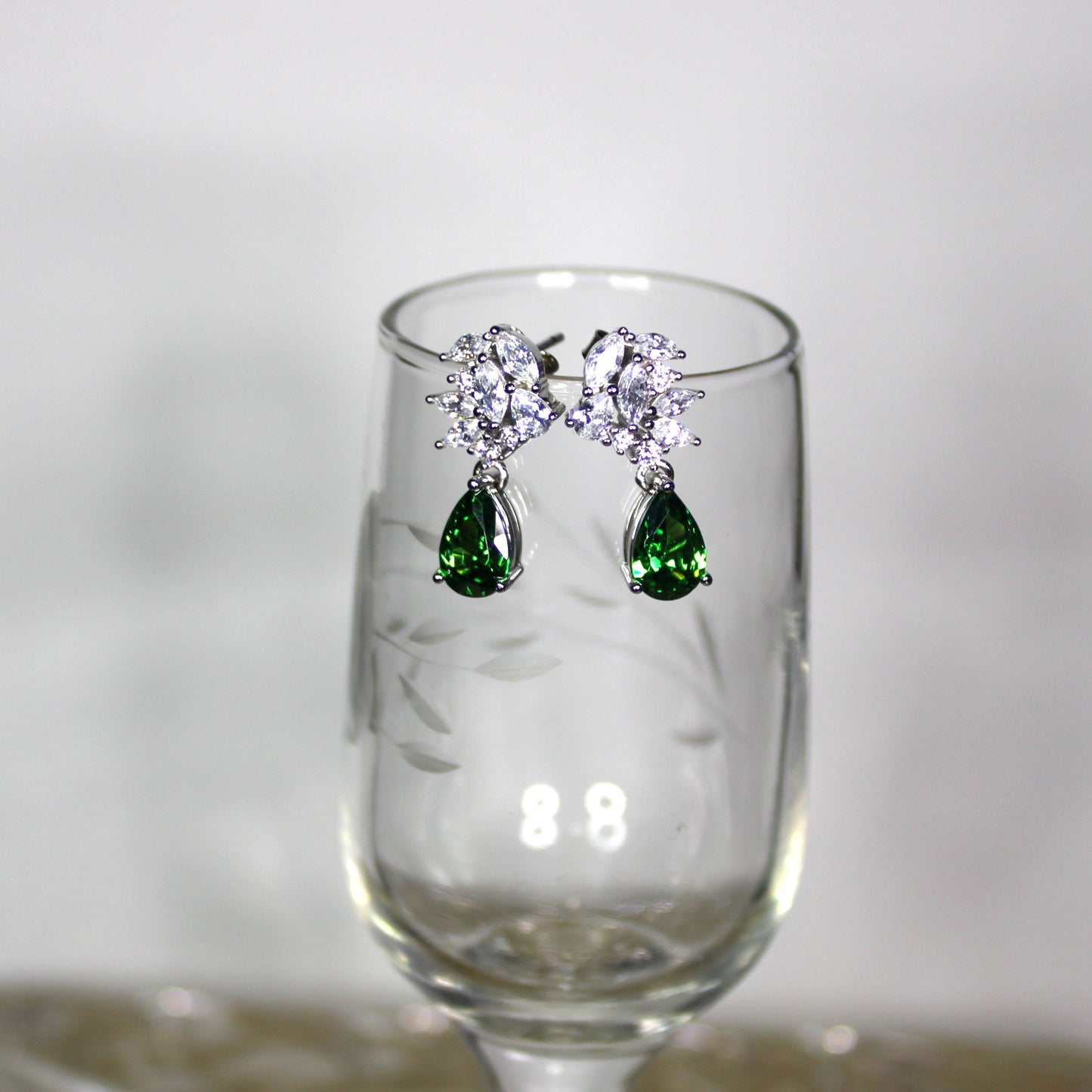 Emma: Rhodium-plated .925 Sterling Marquise Diamond with Teardrop Emerald Earrings