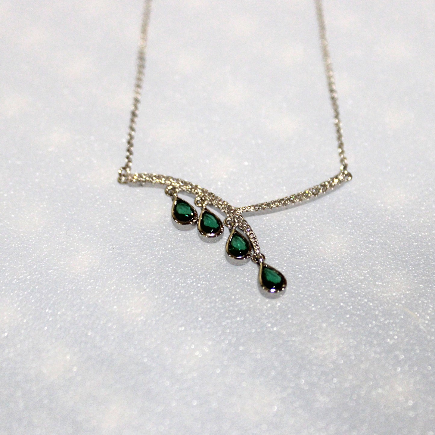Aurora: Rhodium-plated .925 Sterling lab-created Emerald Teardrop and Diamond Earrings